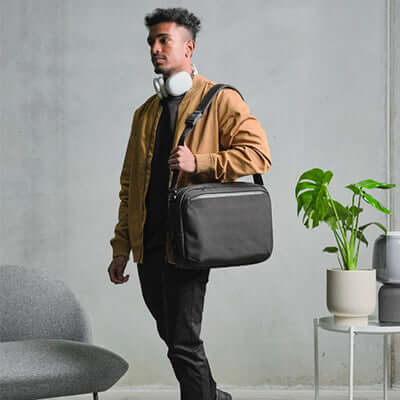 Stylish individual carrying the Alpaka Tech Brief Pro 600D Backpack, perfect for work and commuting.