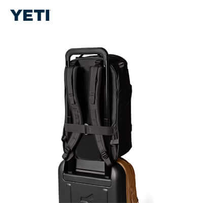 Yeti Ranchero™ 27L Everyday Carry Backpack shown on luggage for easy transport.