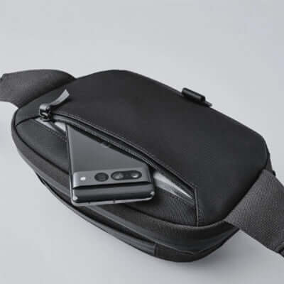 Alpaka Waist Pack 600D featuring a sleek design with smartphone in pocket for easy access.