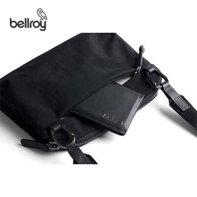 Bellroy Tokyo Side Sling Bag open showcasing a sleek design and a wallet inside, perfect as a Corporate Gift.