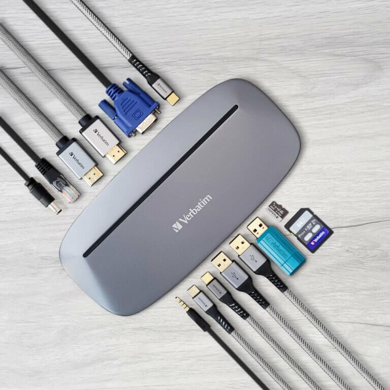 Verbatim 13-in-1 Type C Docking Station with AC Adaptor 100W and various connectivity cables on a wooden surface.