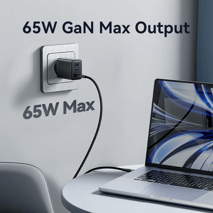 Vention 3-Port USB (C+C+A) GaN Charger 65W plugged into the wall, charging a laptop efficiently with 65W output.