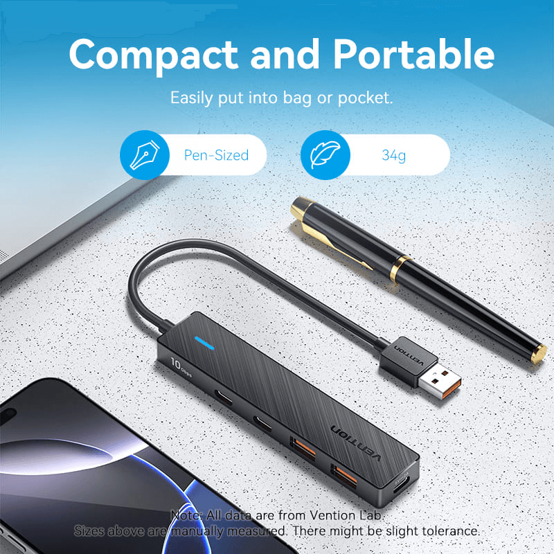 Vention 5-in-1 USB 3.2 Hub 10Gbps on a desk with a pen, showcasing its compact and portable design.