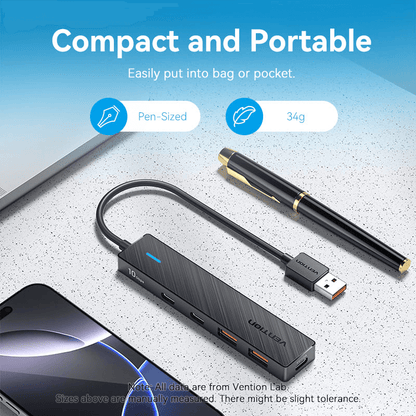 Vention 5-in-1 USB 3.2 Hub 10Gbps on a desk with a pen, showcasing its compact and portable design.