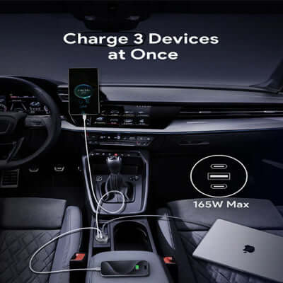 Aukey CC-P4 Pathfinder Mix 3 165W Fast Charging Car Charger in a vehicle interior, charging three devices simultaneously.