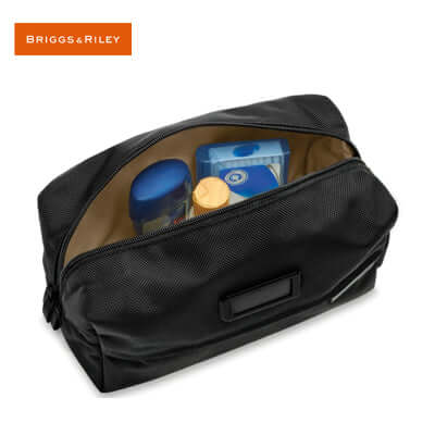 Briggs & Riley Baseline Everyday Essentials Kit with organized toiletries and contrasting interior.