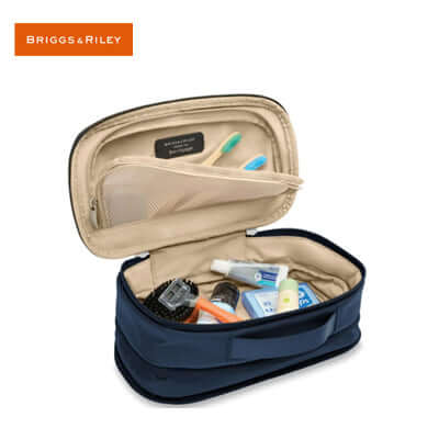 Briggs & Riley Baseline Expandable Essentials Kit showcasing organized toiletries in navy