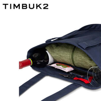 Timbuk2 Canvas Shop Tote Bag showcasing interior organization with wine bottle and storage items.