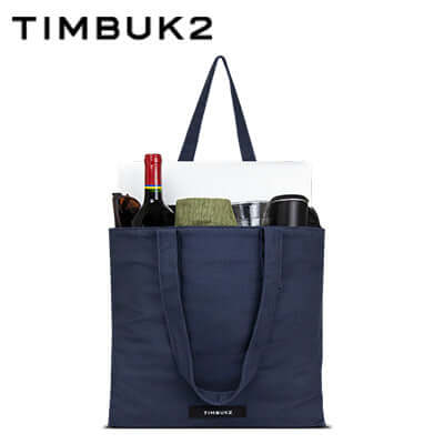 Timbuk2 Canvas Shop Tote Bag filled with items like wine, a picnic blanket, and cups.