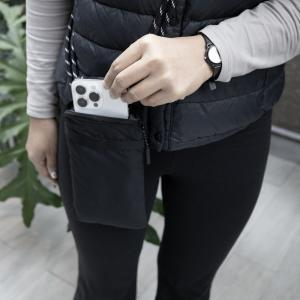 Person using the BrandCharger Pico Crossbody Bag to hold a smartphone in a compact and stylish manner.