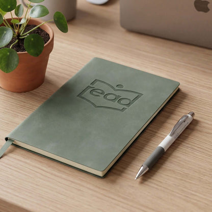 Genoa Soft Cover Notebook and Pen Gift Set on a wooden desk with a potted plant, perfect for corporate gifts.