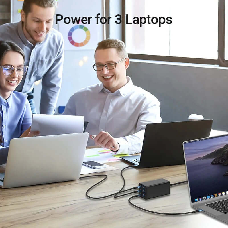 Vention 6-Port USB Desktop GaN Charger powering 3 laptops in a dynamic office environment.