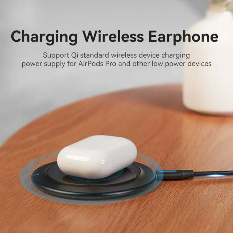Vention Wireless Charger 15W Black Mirrored Surface Type charging wireless earphones on a wooden surface.