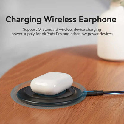 Vention Wireless Charger 15W Black Mirrored Surface Type charging wireless earphones on a wooden surface.