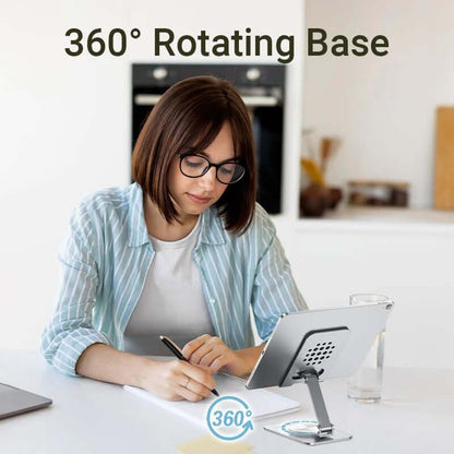 Vention Articulating Desk Phone Stand with 360° Rotatable Base used by a woman working at her desk.