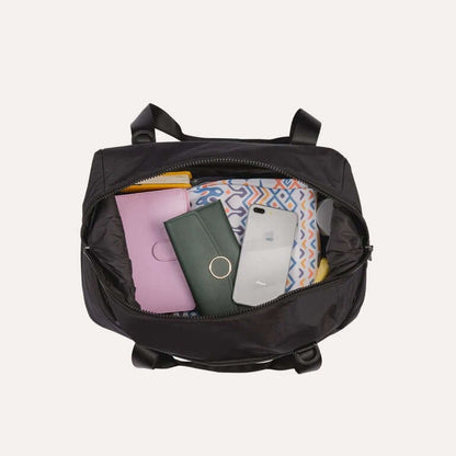 Bagsmart Zoraesque Duffel Bag interior packed with essentials including wallet, phone, and colorful items.