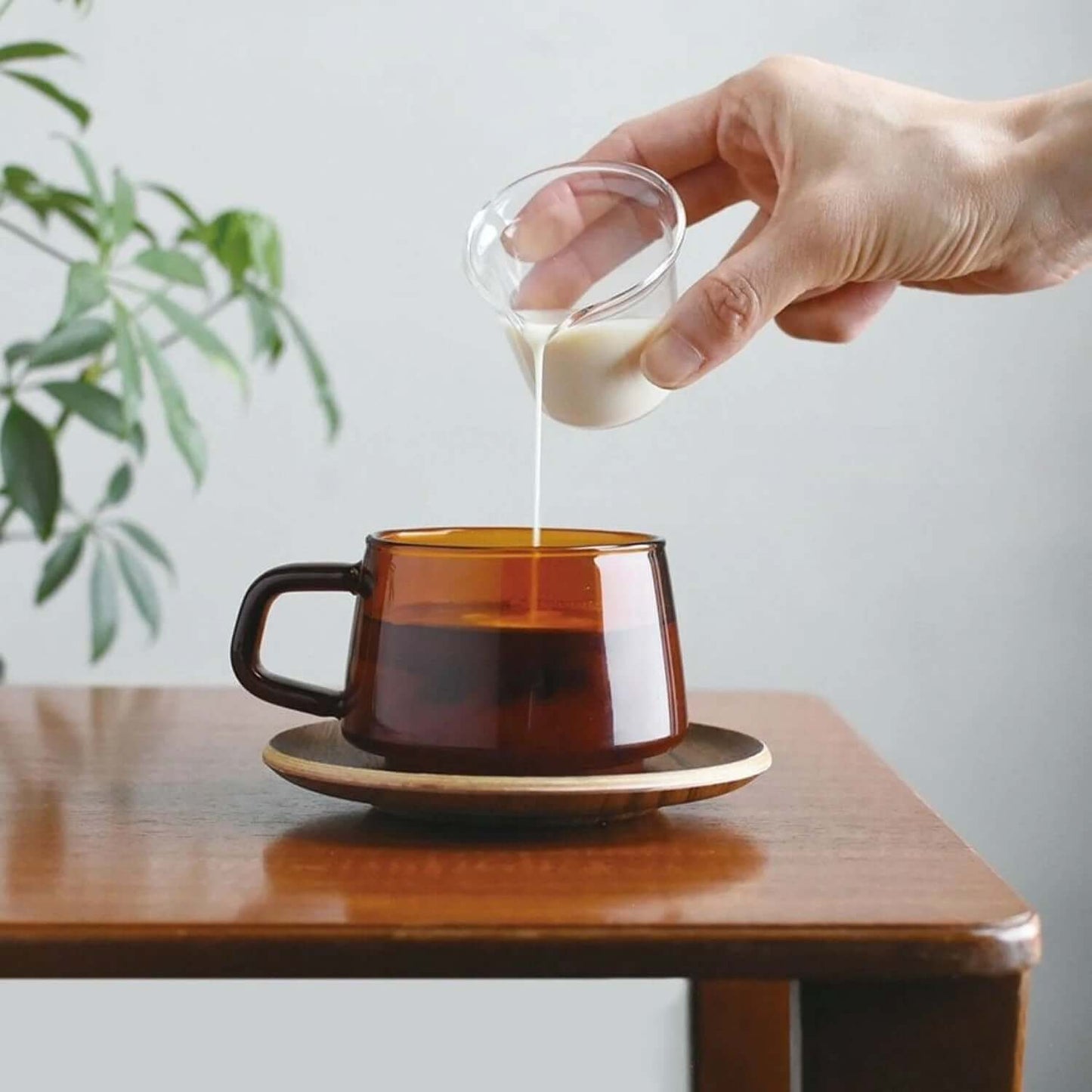 Kinto Sepia Cup 270ML with milk being poured, showcasing a modern design and smooth drinking experience.