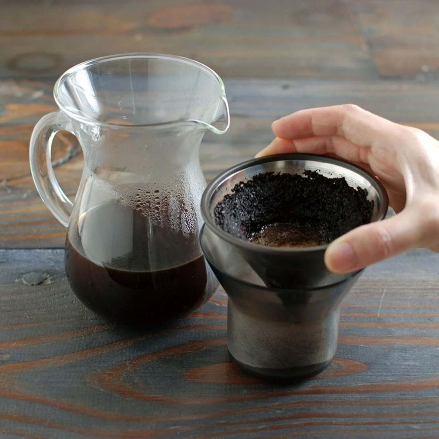 Kinto SCS Coffee Carafe Set 4Cups with coffee brewing equipment on a wooden table.