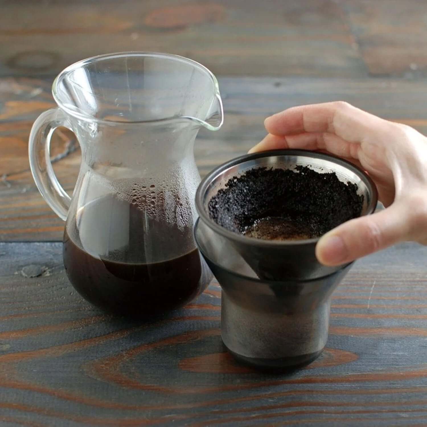Kinto SCS Coffee Carafe Set 4Cups with coffee brewing equipment on a wooden table.