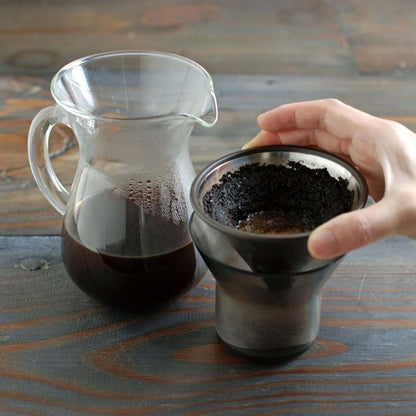 Kinto SCS Coffee Carafe Set 4Cups with coffee brewing equipment on a wooden table.