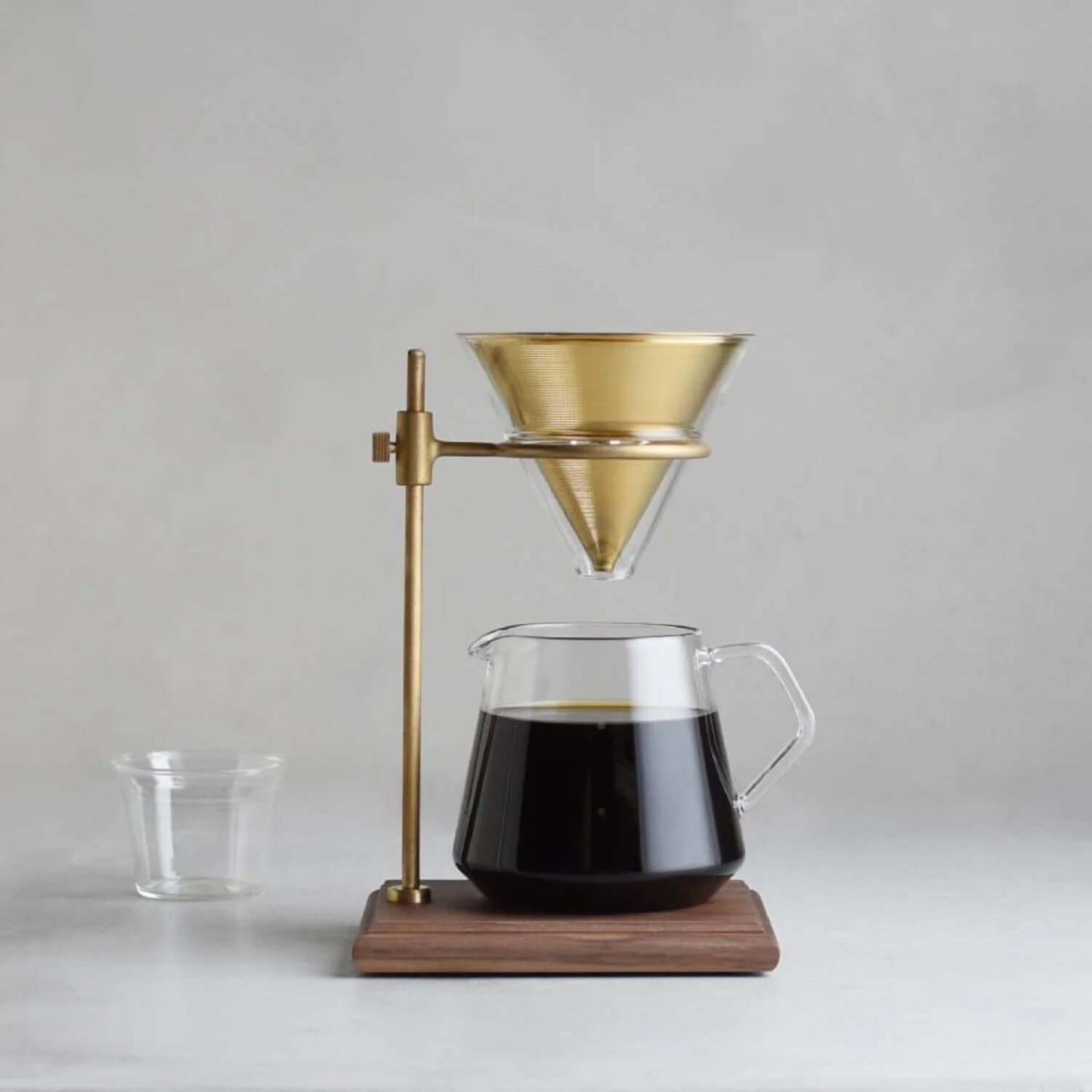 Kinto SCS-S02 Brewer Stand Set 4Cups with elegant gold funnel and glass coffee pot for slow brewing.