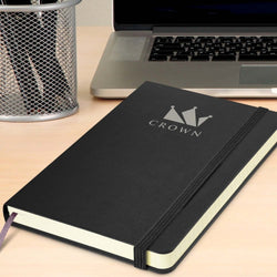 Moleskine Classic Hard Cover Notebook - Medium on a desk with a laptop, ideal for Corporate Gift Singapore.