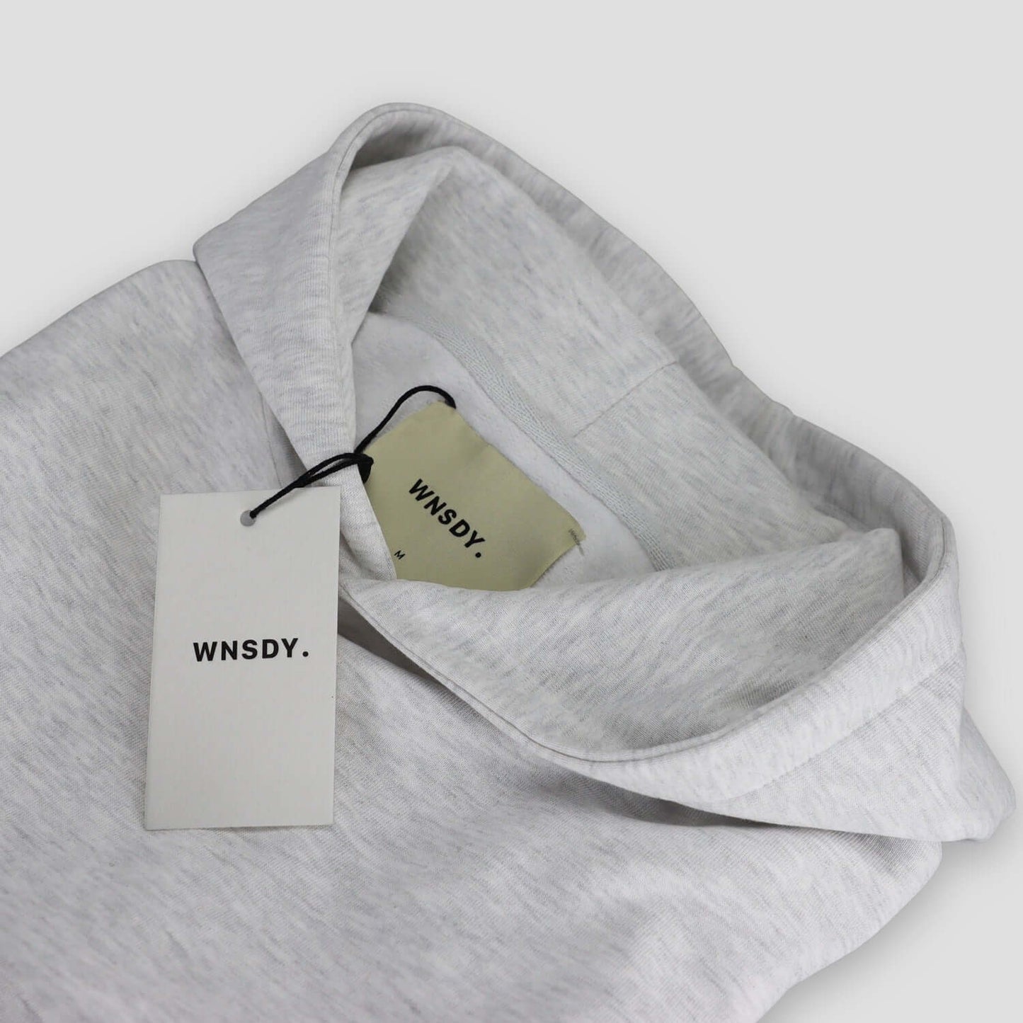 WNSDY Essential Hoodie close-up showing tag and fabric detail, ideal for corporate gift.