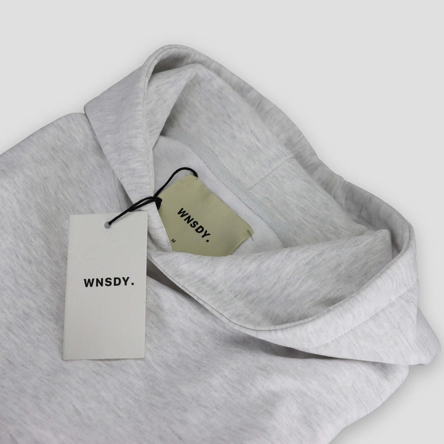 WNSDY Essential Hoodie close-up showing tag and fabric detail, ideal for corporate gift.