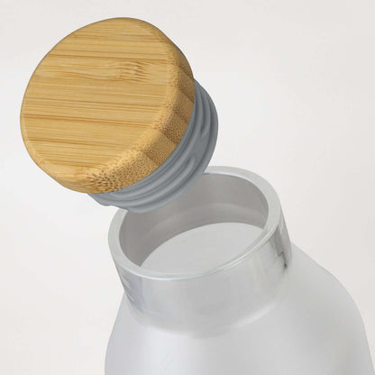NATURA Ida Glass Bottle with a natural bamboo lid, showcasing its elegant design and functionality.