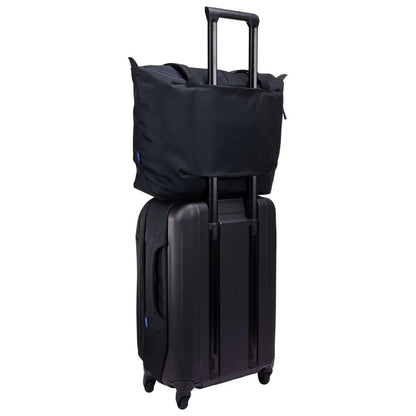 Thule Subterra 2 Tote Bag on top of a rolling suitcase, ideal for travel and corporate gift.