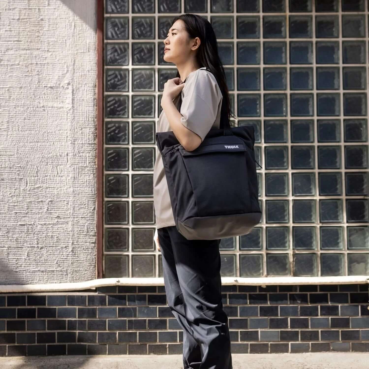 Thule Paramount Tote 22L being carried by a woman, ideal for daily adventures and corporate gifts.
