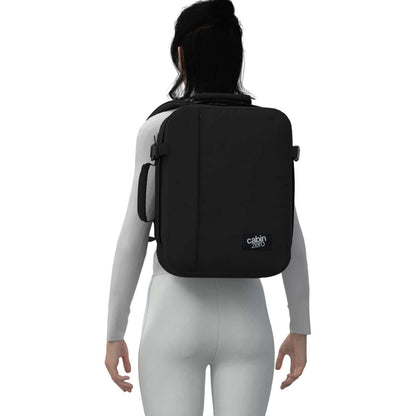 Cabinzero Classic Backpack 28L on a model's back, showcasing sleek design and functionality for travelers.