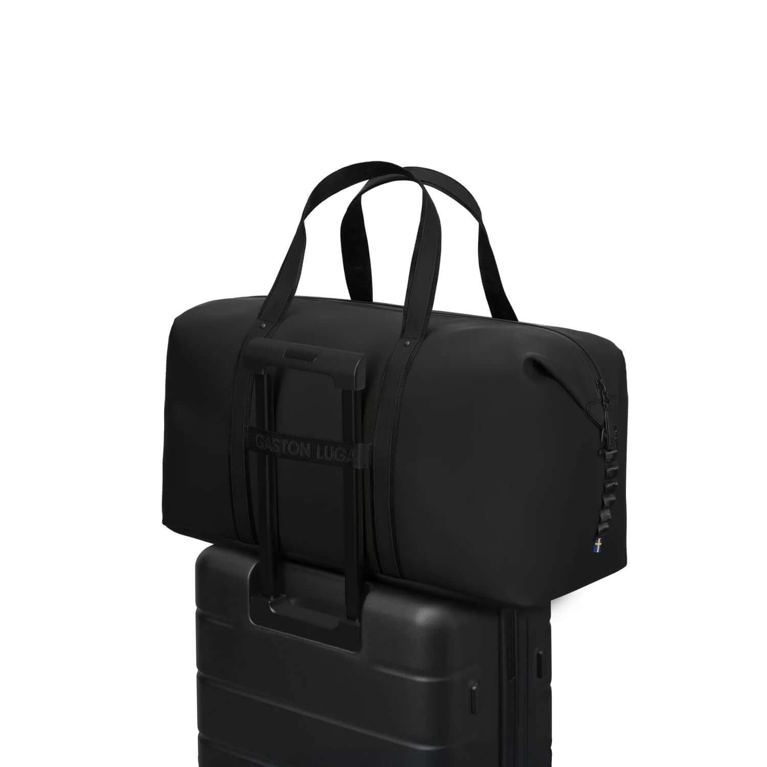 Gaston Luga Dash Weekender 2.0 Large stylishly placed on top of a suitcase, ideal for corporate gifts.