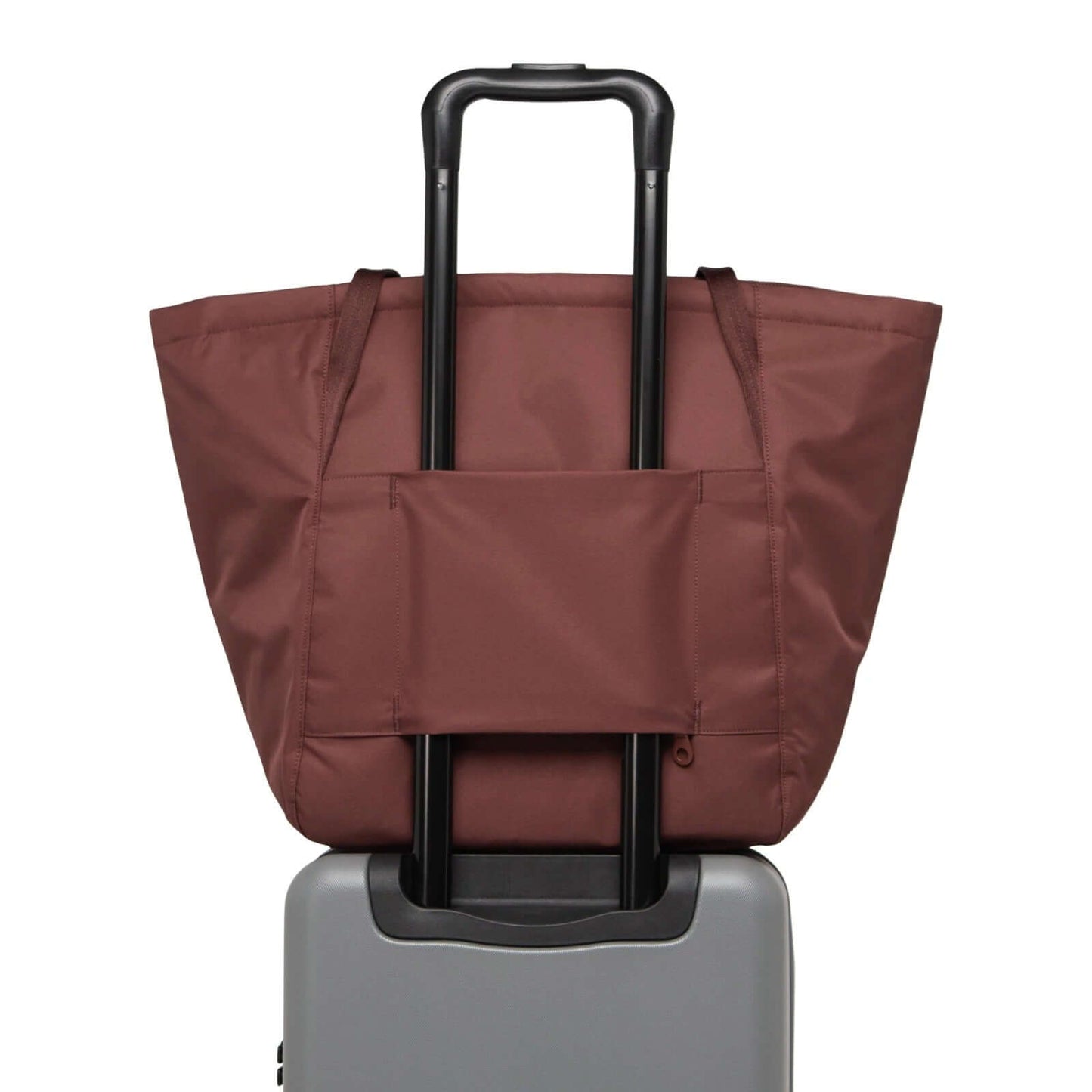 Herschel Joana Foldable Tote Bag displayed on a suitcase, showcasing its modern design and eco-friendly materials.