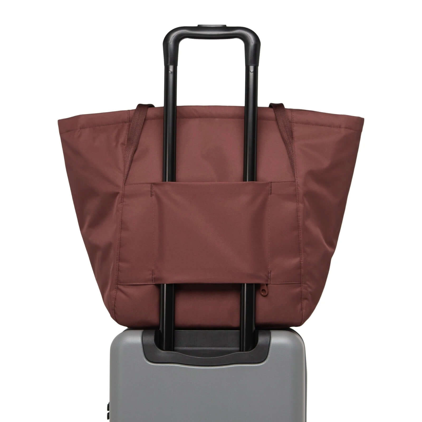 Herschel Joana Foldable Tote Bag displayed on a suitcase, showcasing its modern design and eco-friendly materials.