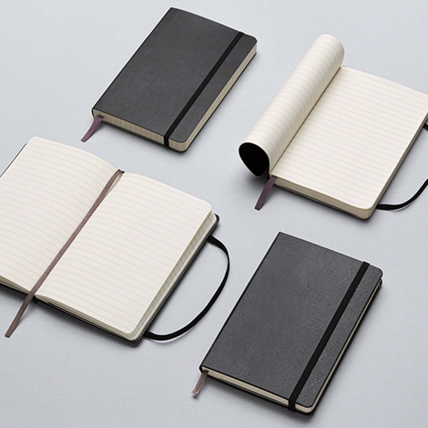 Moleskine Classic Soft Cover Notebook - Large displayed with various configurations and open pages, elegant design perfect for corporate gift.