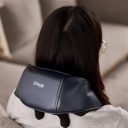 Woman using OTO Q Hug massager for neck and shoulder relaxation, perfect as a corporate gift.