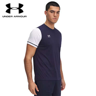 Under Armour Challenger Team Jersey model wearing a navy and white soccer shirt for optimal performance on the field.
