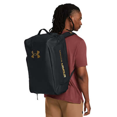 Under Armour Contain Duo Small Backpack Duffle worn on back of a model, showcasing its sleek design and versatility.
