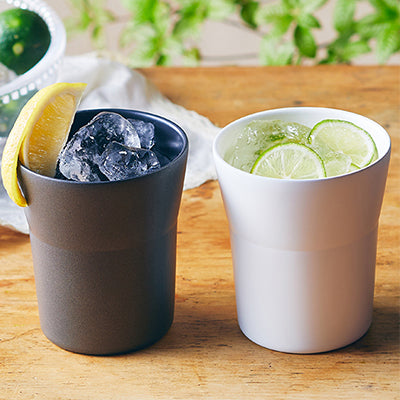 Kyocera 300ml Cerabrid Tumbler in dark and white colors with ice and lemon garnish, perfect for beverages.