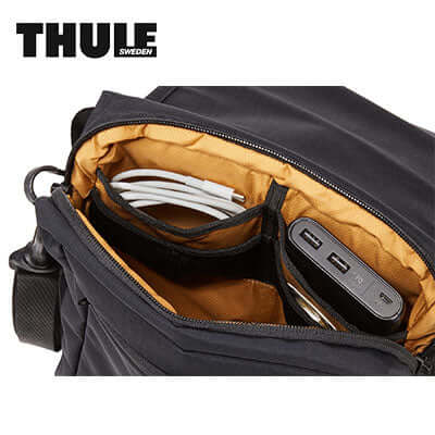 Thule Paramount Crossbody Bag interior showing organization pockets for cables and a power bank, ideal corporate gift.