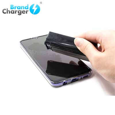 BrandCharger Spare Lite 3 in 1 Sanitizer Case spraying sanitizer on a smartphone screen.
