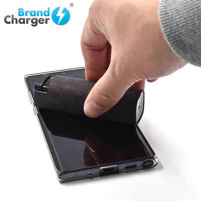 BrandCharger Spare 3 in 1 Sanitizer Case in use sanitizing a smartphone, showcasing its effectiveness as a corporate gift.