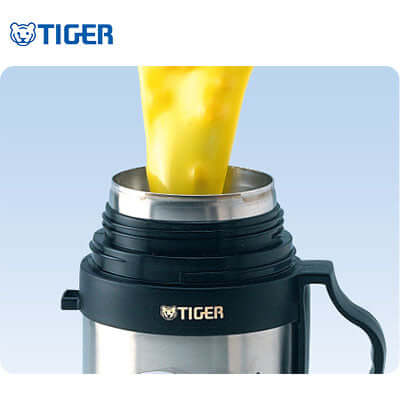 Tiger Food Stainless Steel Jar with Bag MCW-P pouring content with a vacuum-insulated design.