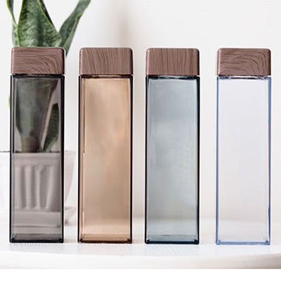 BPA Free Square Water Bottle with Bamboo Lid 500ml in various colors on a table.