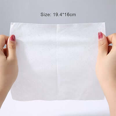 Hands holding a 75% Alcohol Wet Wipe measuring 19.4cm x 16cm, showcasing its size and texture.