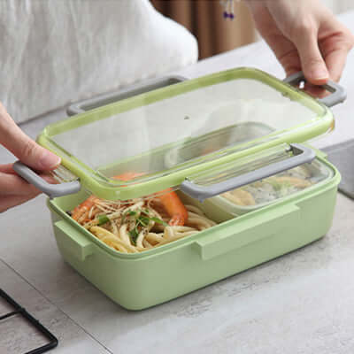 Microwave Ready Bento Lunch Box being opened, showcasing its compartments and leak-proof design for easy meals.