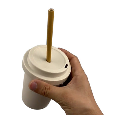 Hand holding an Eco-friendly Bamboo Fiber Mug with Bamboo Straw, showcasing its lightweight and sustainable design.