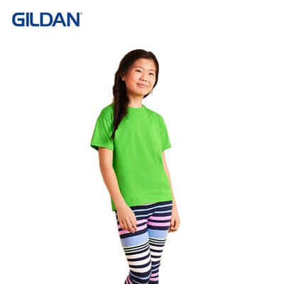 Gildan Premium Cotton Youth T-Shirt in vibrant green color, worn by a smiling young girl with striped leggings.