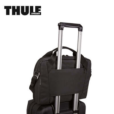 Thule Crossover 2 13″ Laptop Bag attached to suitcase for travel convenience.